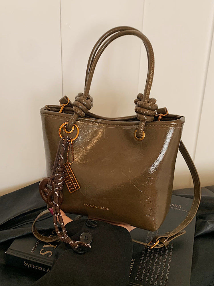 Yüksək səviyyəli, trenddə olan qadınlar üçün kiçik çanta, 2025-ci ilin yeni payız/qış üslubunda, vedrə çantası, sadə lüks, niş üslublu çarpaz bədən çantası.