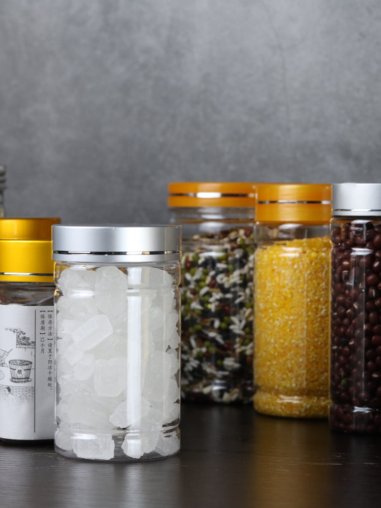 Alüminium qapaqlı plastik şüşə qida dərəcəli pet çiçək çayı quru mallar qoz-fındıq plastik qalın qablaşdırma şüşəsi qapaqlı şəffaf möhürlənmiş banka