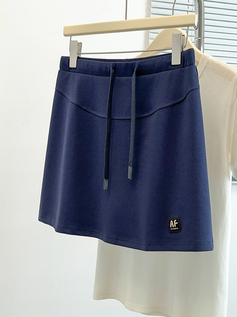 2026-cı ilin yayı üçün böyük ölçülü qadın gündəlik idman ətəyi, incə bədən quruluşu üçün yaraşıqlı, ombaları gizlədən, A-xəttli ətək, qısa ətək.