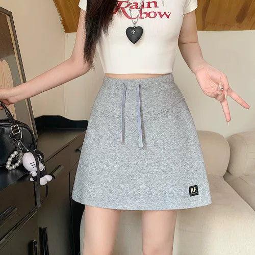 Böyük ölçülü qadın gündəlik idman sviteri, 2026-cı il yay yeni dəbi, yüksək belli, kalçanı örtən, arıqladıcı A-xəttli ətək/qısa ətək