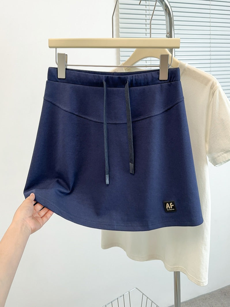 2026-cı ilin yayı üçün böyük ölçülü qadın gündəlik idman ətəyi, incə bədən quruluşu üçün yaraşıqlı, ombaları gizlədən, A-xəttli ətək, qısa ətək.